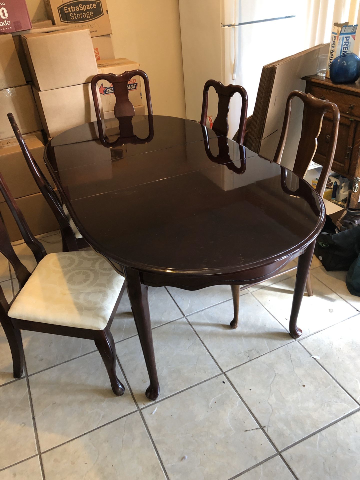 Beautiful wood dining table with leaf and 5 chairs. Legs of table can be removed for moving.