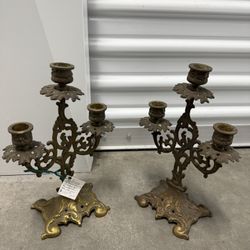 A pair of vintage ornate brass three-light candelabra.