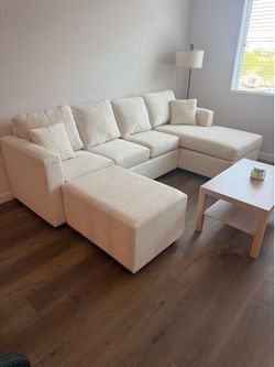 Brand new cream sectionals with free ottoman