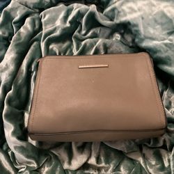 Has A Lot Of Pockets, A Little Pouch In The Back And A Straap