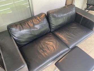 Black leather couch with ottoman