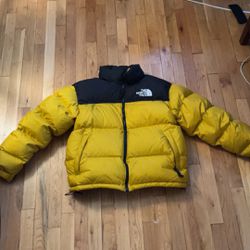 yellow & black north face puffer
