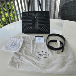 This is an Authentic Prada Soft Calfskin Impunture Diagramme Tote Black bag.