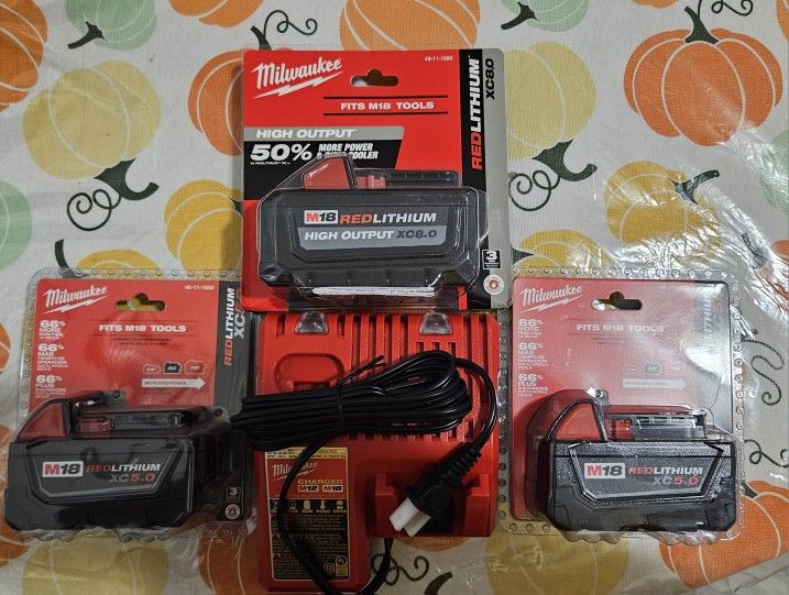 MILWAUKEE M18 AND M12 CHARGER WITH 2 5.0 M18 BATTERIES AND 1 8.0 M18 BATTERY