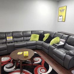 HUGE GRAY OR BLACK SECTIONAL WITH 3 RECLINERS.