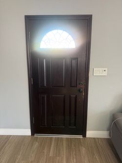 Dark Wood Entry Door with Fan Window