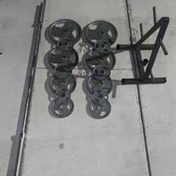 Weight plate set with rack and Olympic barbell 300lbs total 