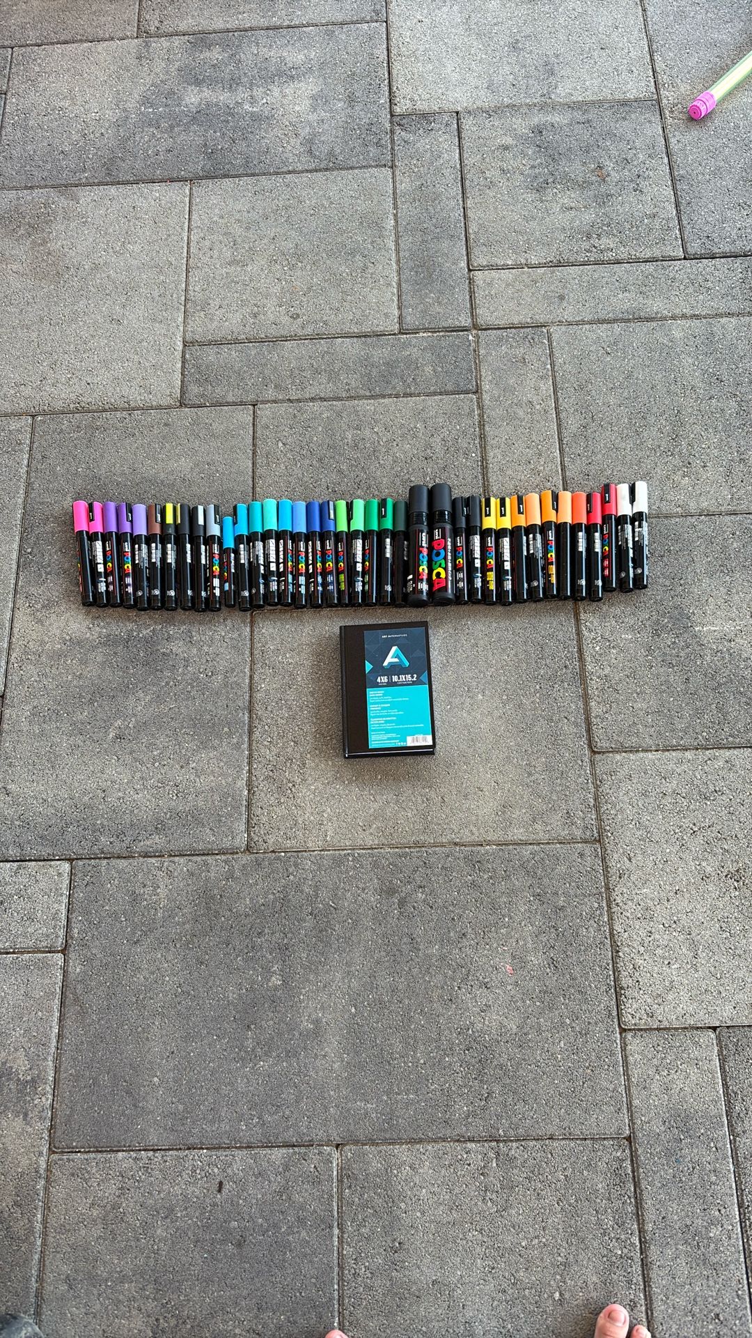 38 Posca markers. Some used, some not used. And a notebook to use them.