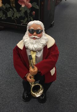 Musical santa playing the saxophone on and off