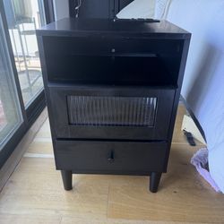 Black wooden nightstand with fluted glass drawer LED lights and charging station