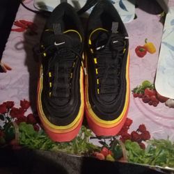 This is a Nike Air Max 97 'Hanshin Tigers' in the Black, Chile Red, and Magma Orange colorway. 