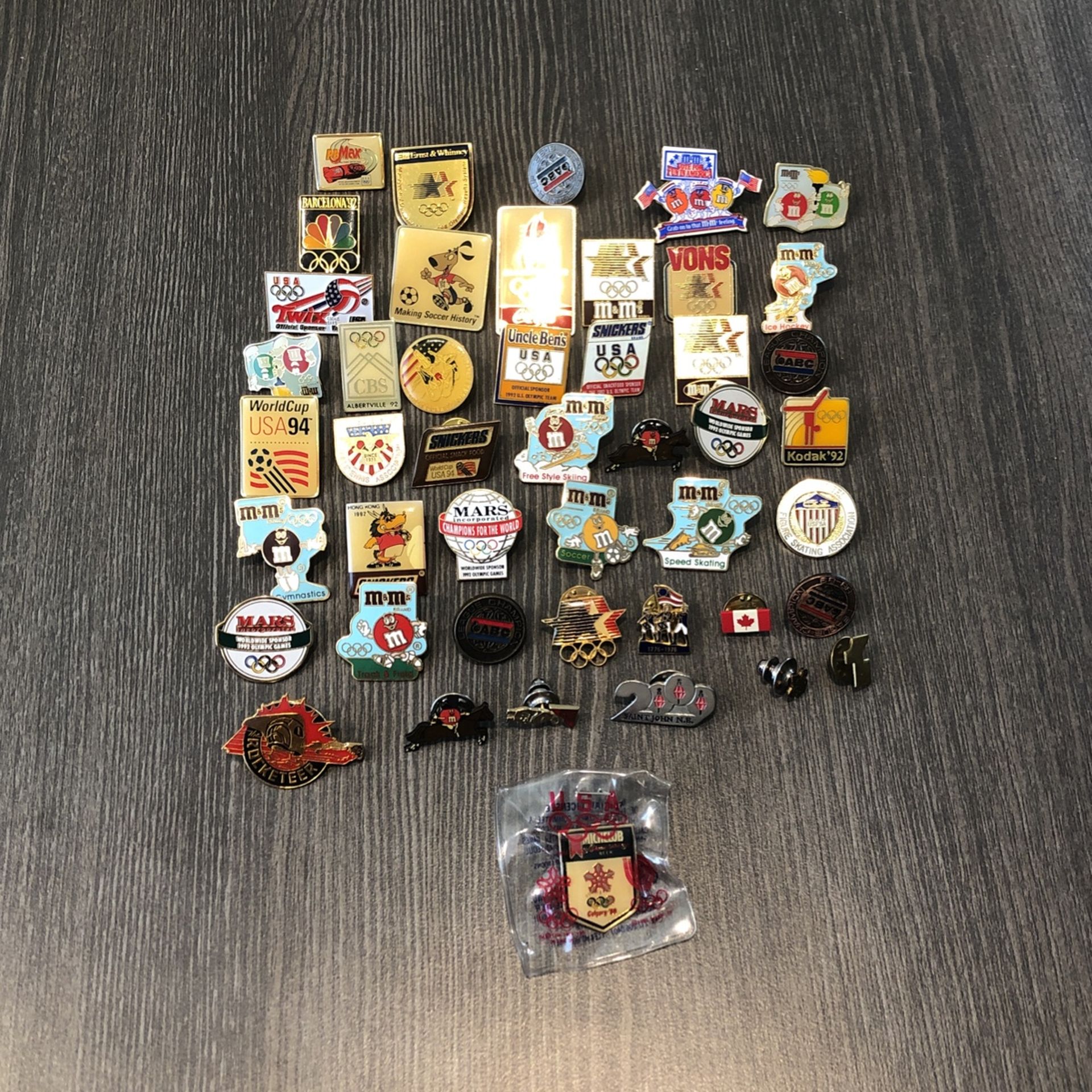 45 sponsored olympic metal collectors pins.    Various sporting events of different years