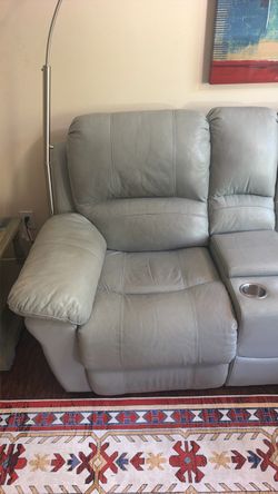 Light blue leather reclining loveseat