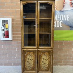 Tall cabinet with shelves glass doors and stoarge