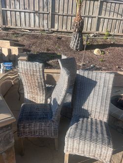 Six wicker patio chairs