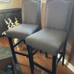 2 Gray Studded Bar Stools Seat At 28” Dark Wood Legs OBO