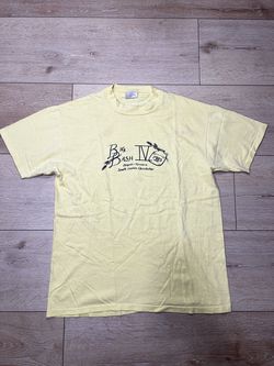 vintage yellow graphic t-shirt featuring a "Big Bash IV" design from 1983