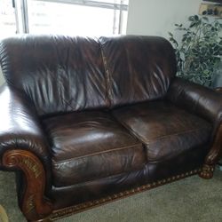 Deep brown leather couches with foot rest