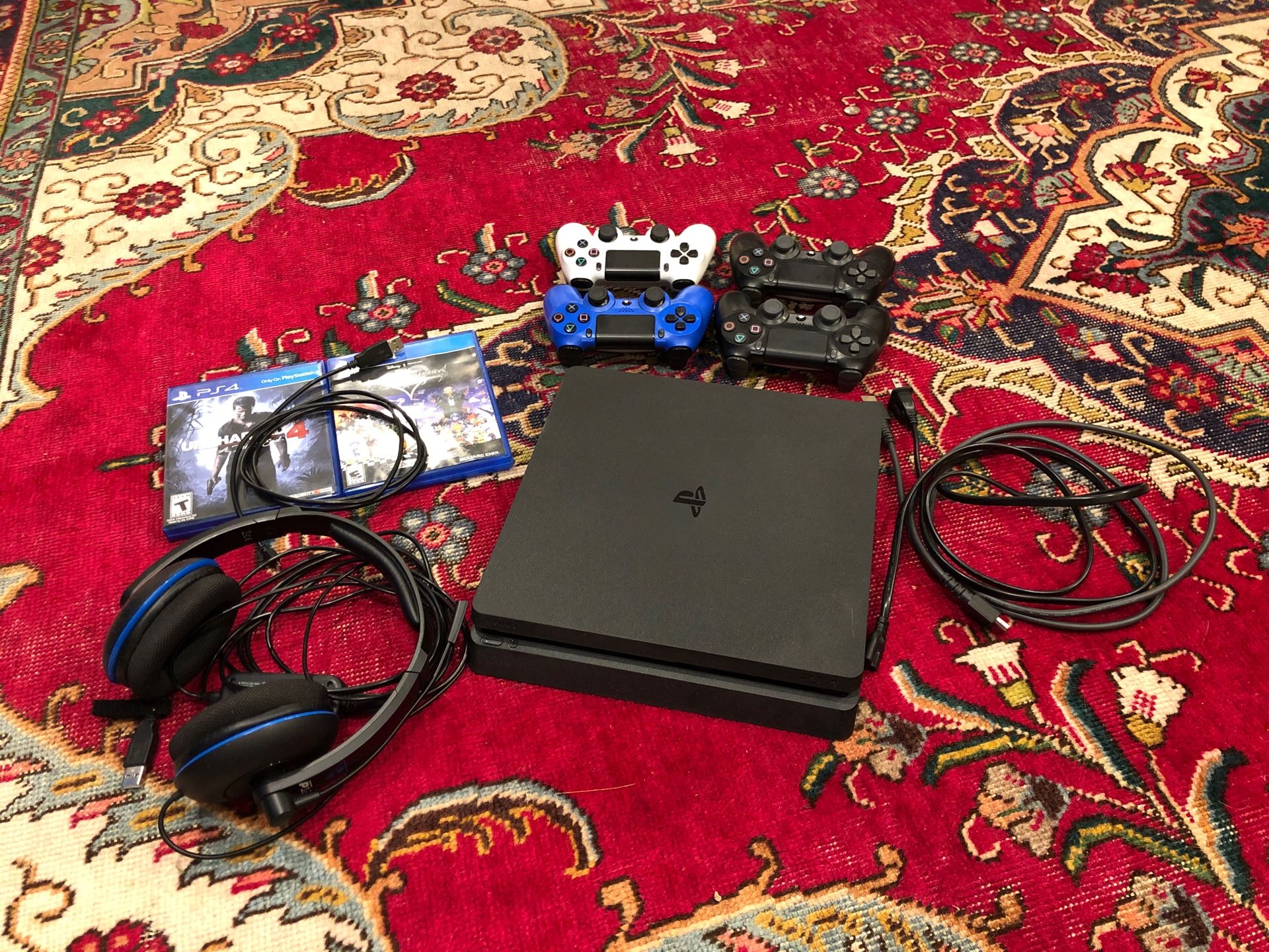 PS4 Slim with 4 controllers, wired headset, and two games