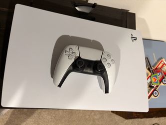 PS5 with controller and games. Media Controller
