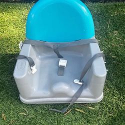 Gray Booster Seat With Blue Backrest. Trademark Brand.