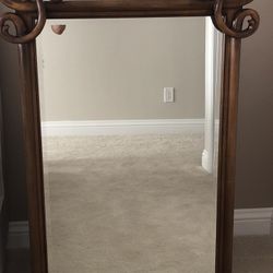 Wood with scroll framed beveled mirror