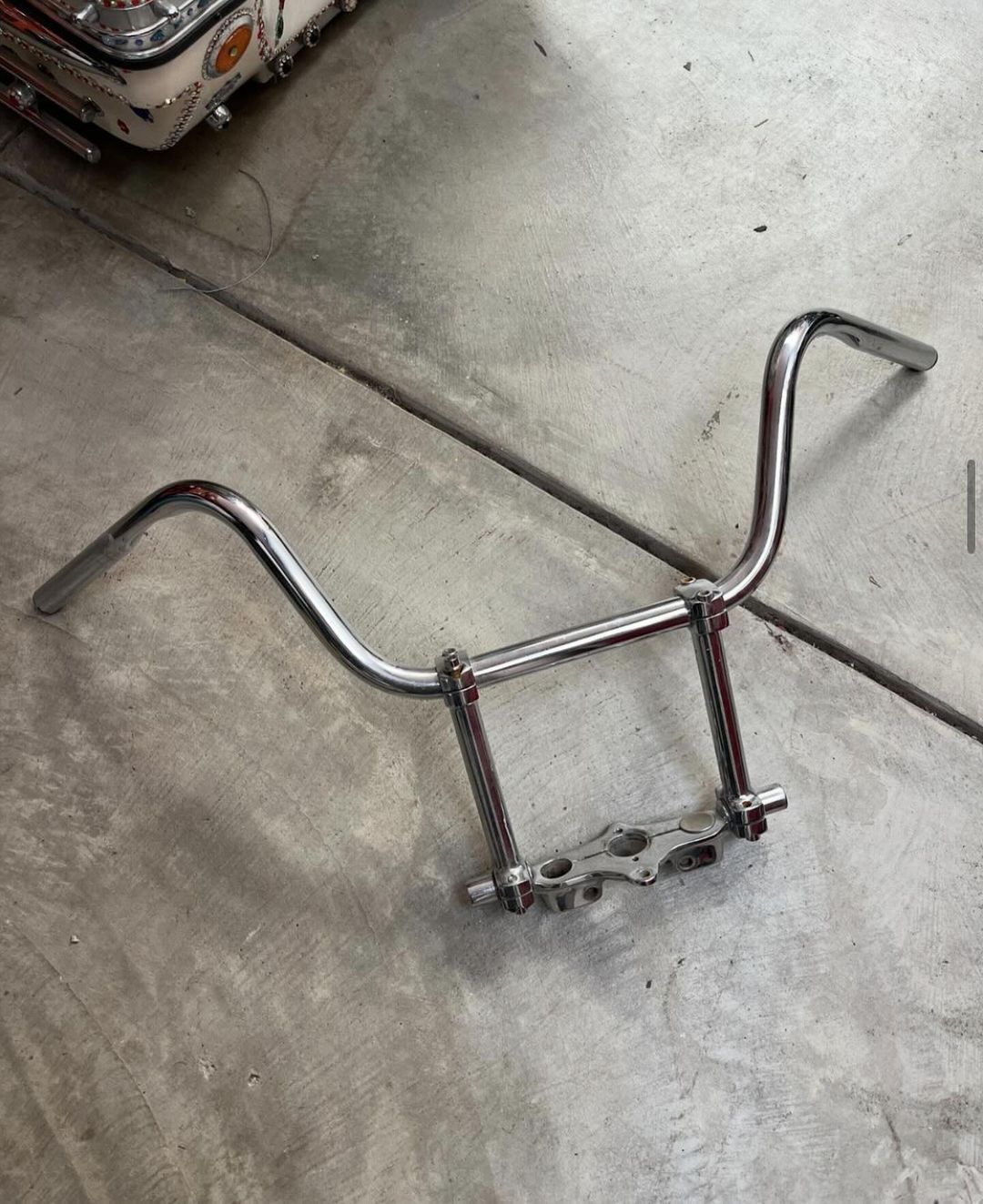 OEM Chrome in-line top clamp, 8" risers, and bars.