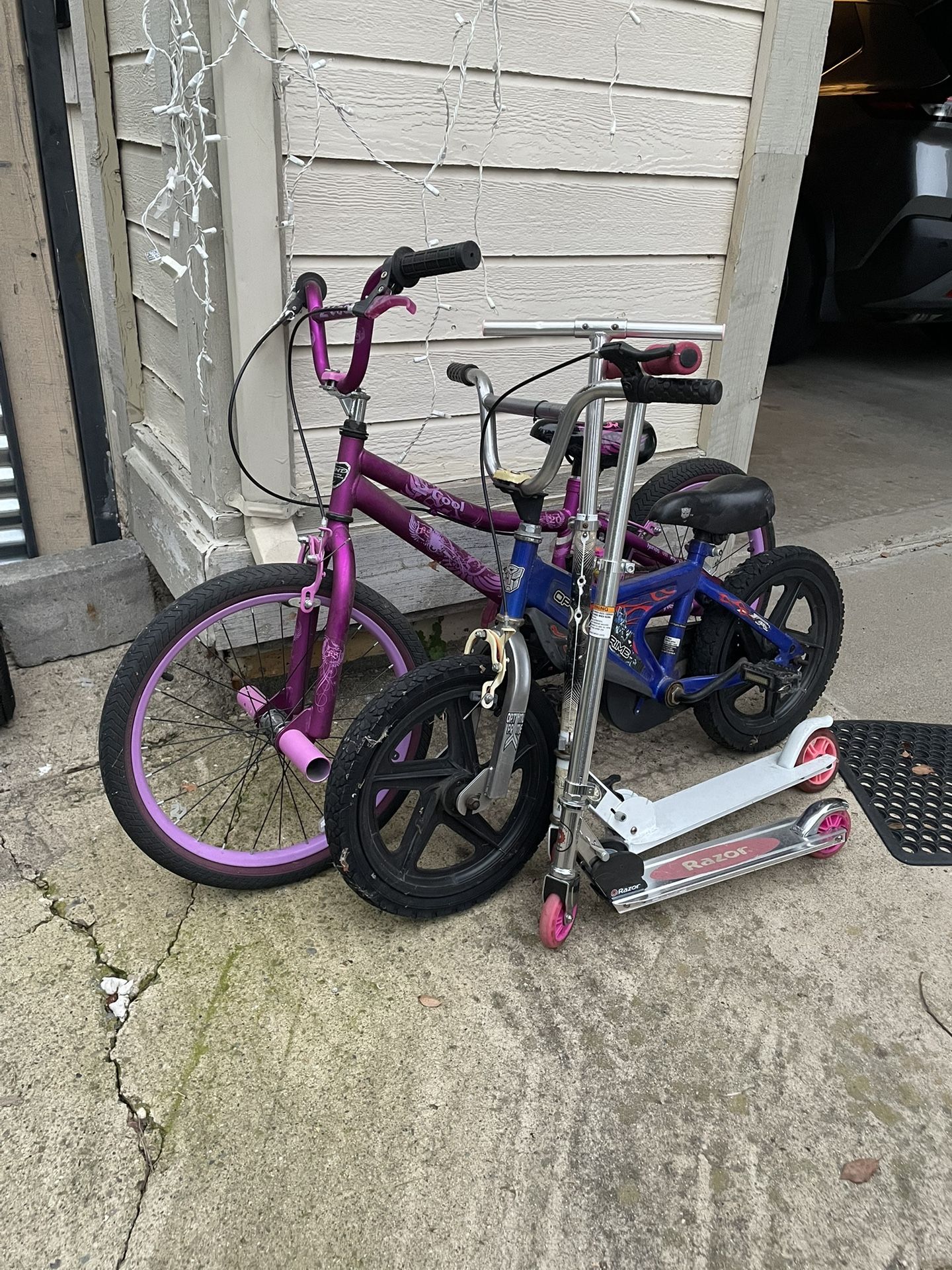 Two Kids Bicycles And Two Scooters