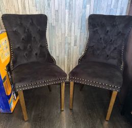 2 black tufted dining chairs
