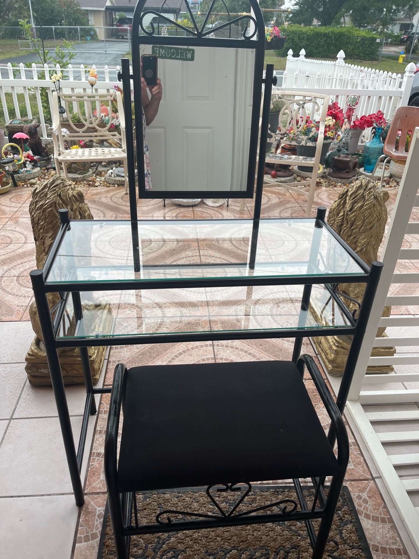 A metal vanity with a nice mirror and a very beautiful, high-quality stool. It measures 30 inches in length, 15 inches in width, and 29 1/2 inches in