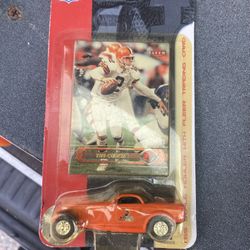 Tim Couch Fleer football trading card and a toy car.