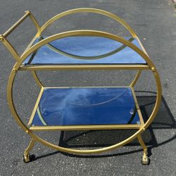 Round gold bar cart with mirrored shelves