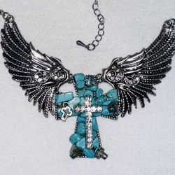 Turquoise, silver necklace with wings with matching earrings.