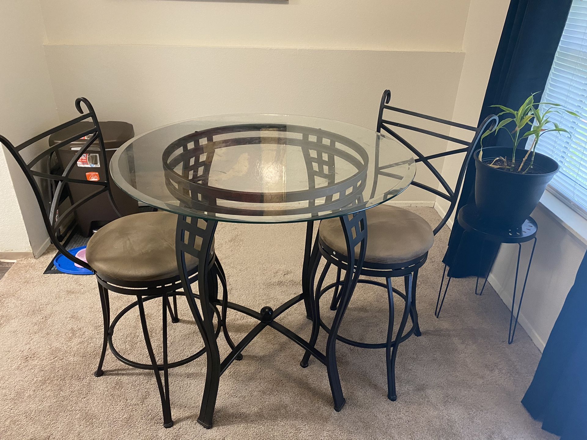 Small round glass top table with stools