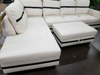 White faux leather sectional with a matching storage ottoman