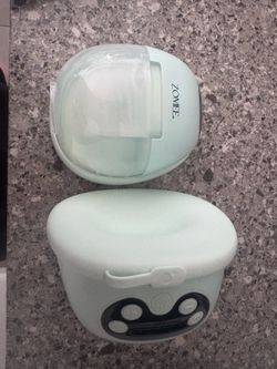 Wearable breast pumps
