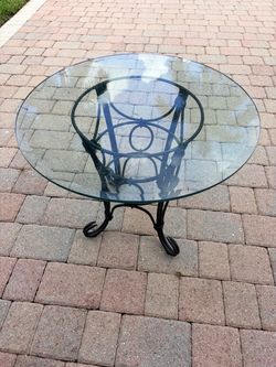 Charming Glass Top table on Gorgeus wrought Iron Bass