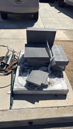 Stone pavers, top caps. Scrap metal/wire, rubber truck bed rug