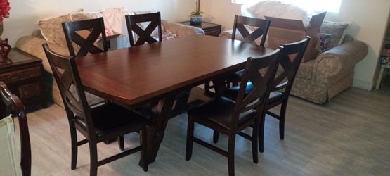 Large dinner table with six chairs