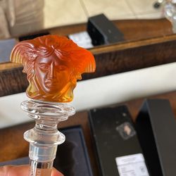 two Versace bottle tops  in original  packaging 