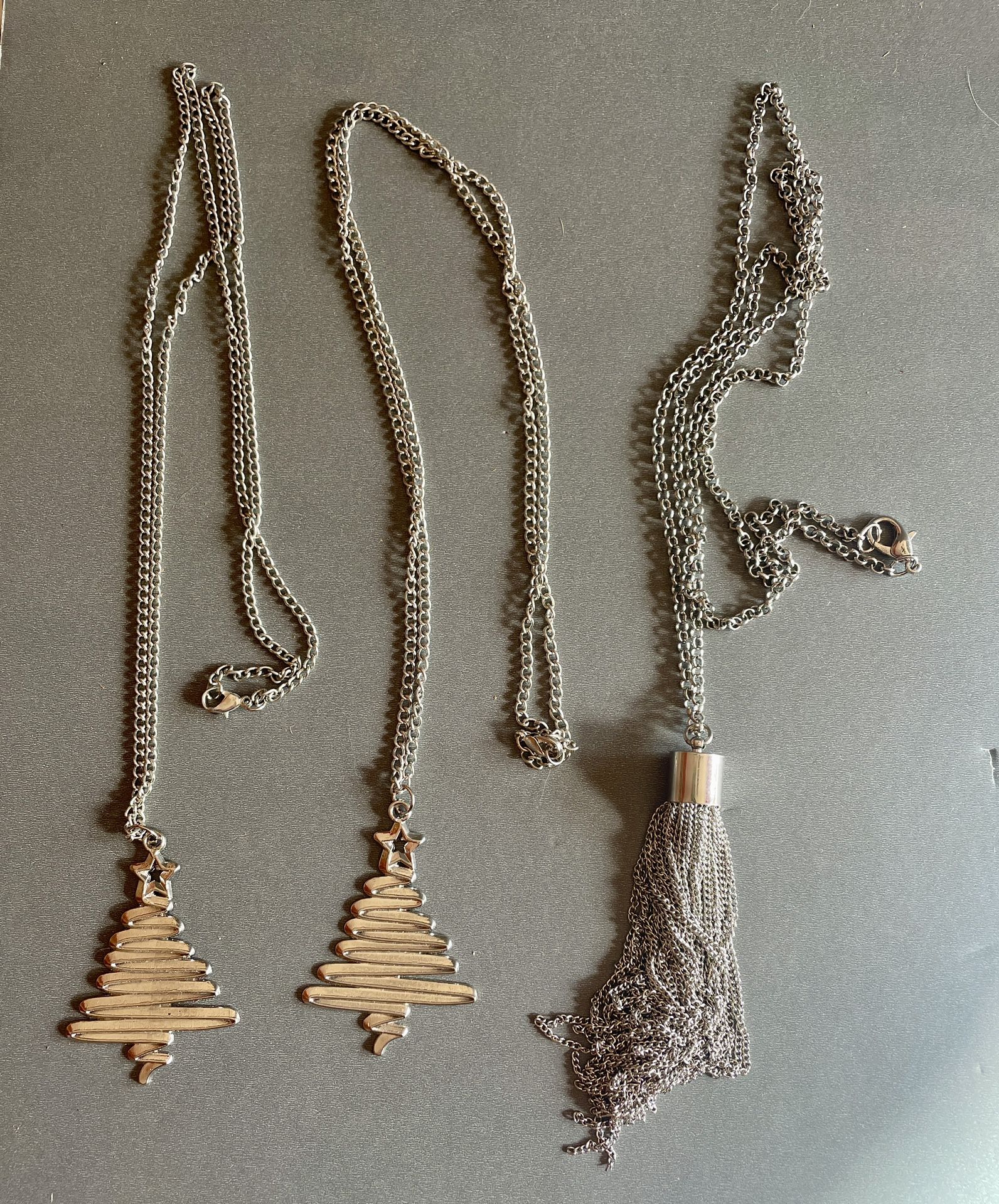 2 Silver-toned Christmas Tree Necklaces And 1  Silver-toned Tassel necklace 