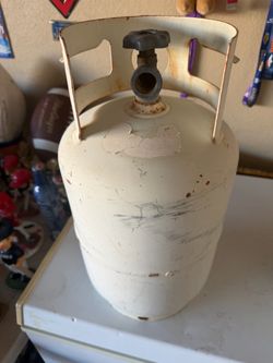 Standard white metal propane cylinder (commonly a 20-pound tank