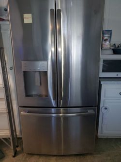 GE refrigerator with ice and water dispenser