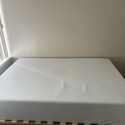 Zinus 12 inch green tea memory foam mattress with a wooden frame