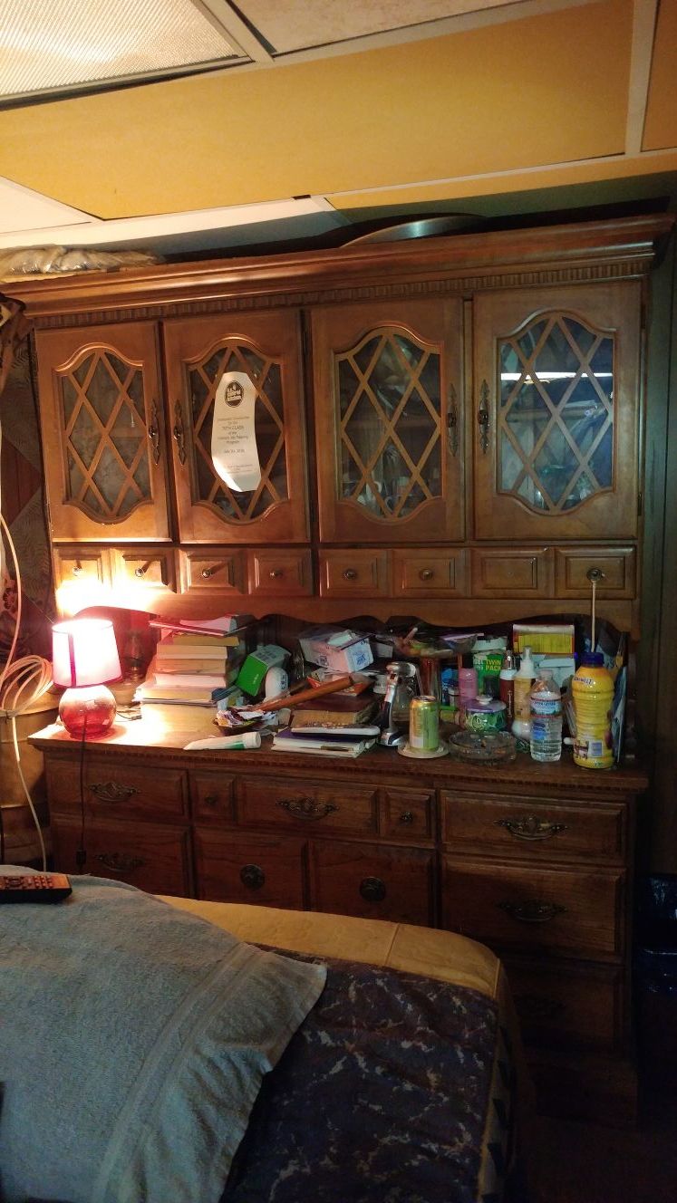 Contemporary maple, brass and four-door china cabinet with multiple-drawer base