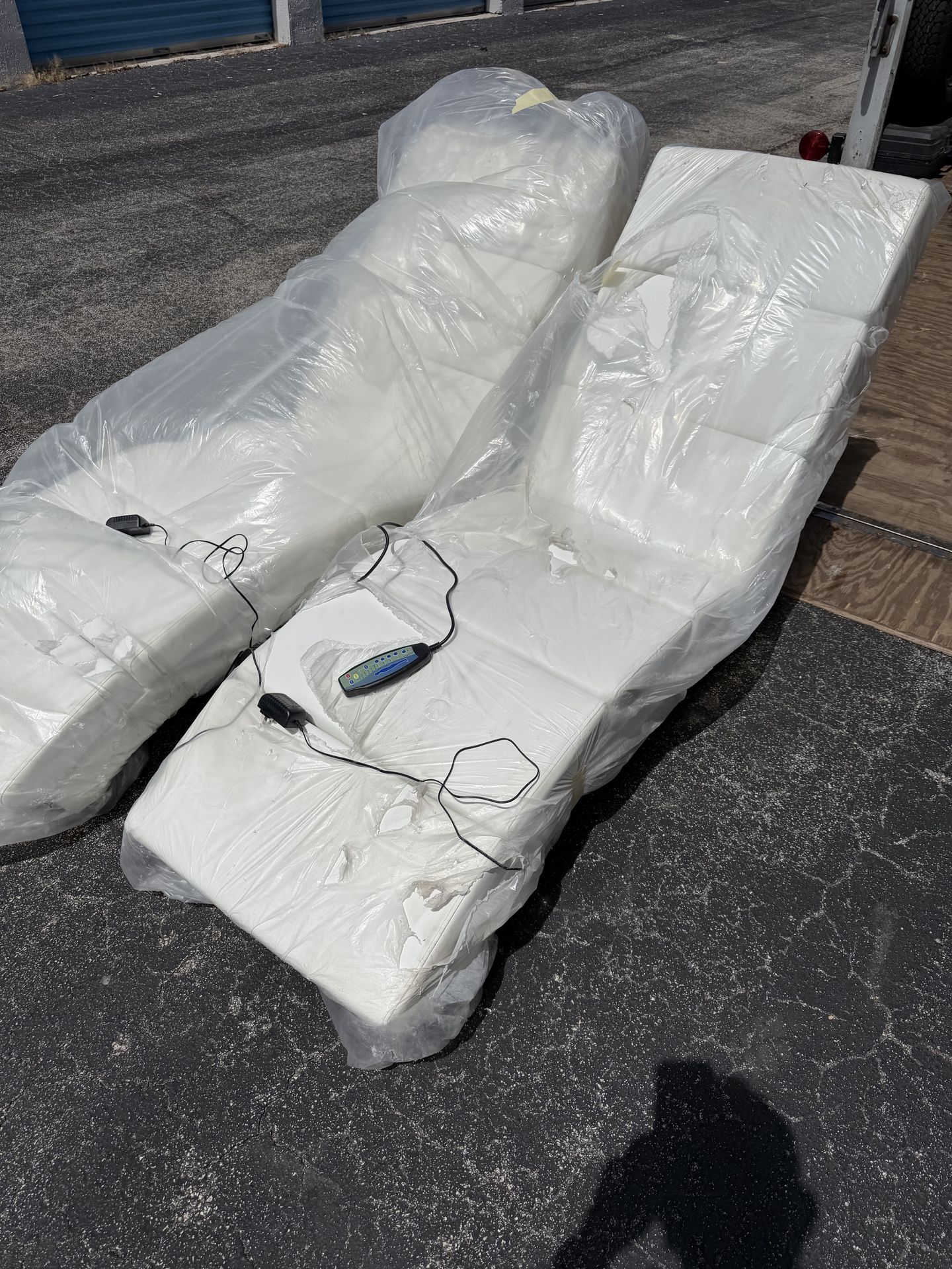 Two white chaise massage chairs