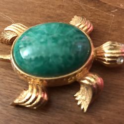 Faux gold AVON turtle locket with green faux stone