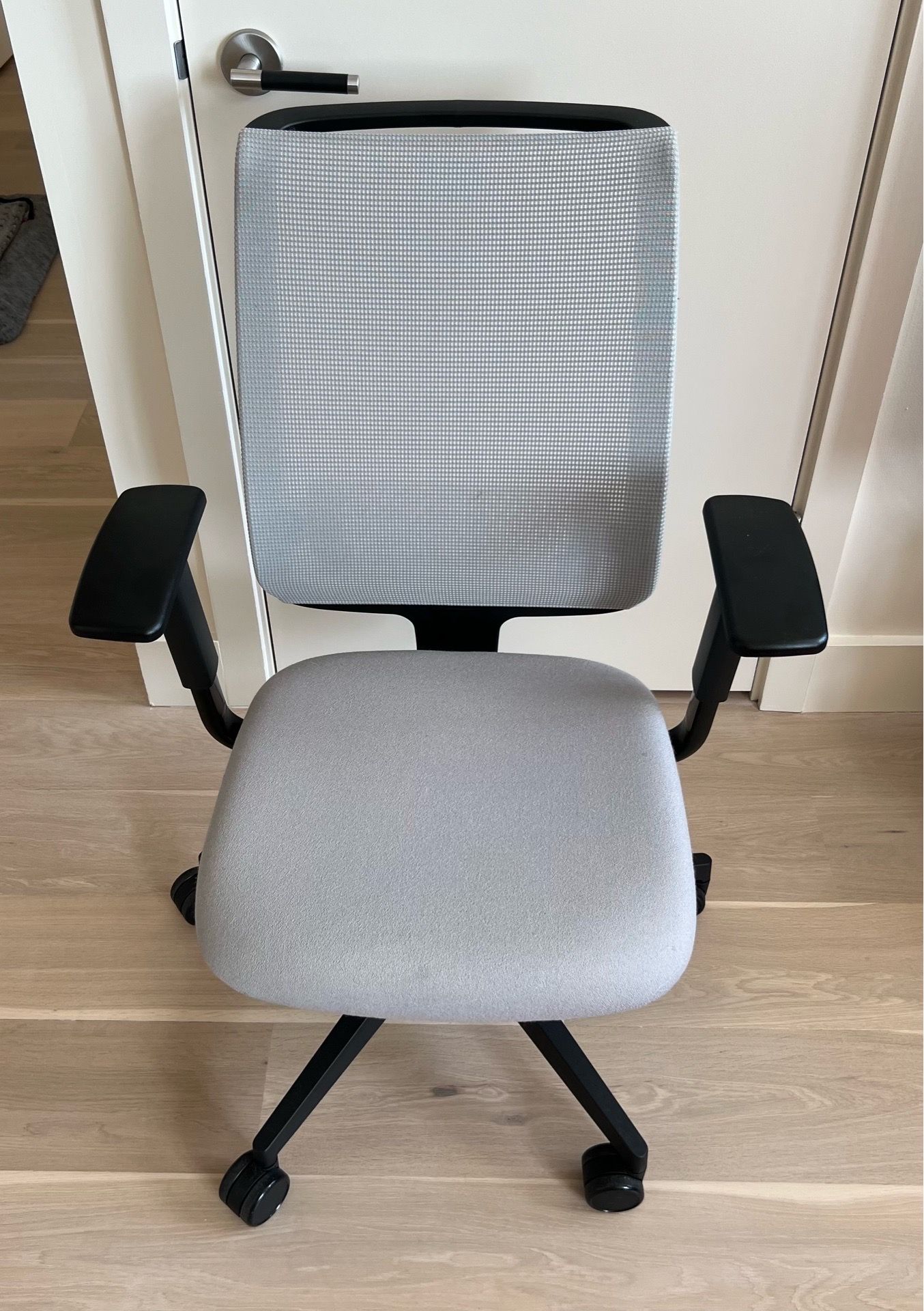 Steelcase Reply task chair with a mesh back and light gray seat fabric