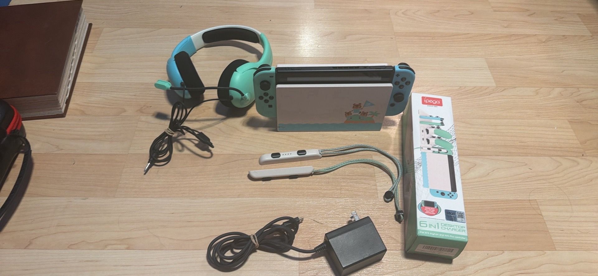 Animal crossing nintendo switch with matching headphones, docking station,matching desktop charger and wrist straps. No trades cash only. No Zelle no