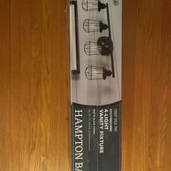 Southbourne 28 in. 4-Light Matte Black Vanity Light with Open Steel Cage Frame